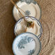 3 mismatched iron earth flat plates in green.