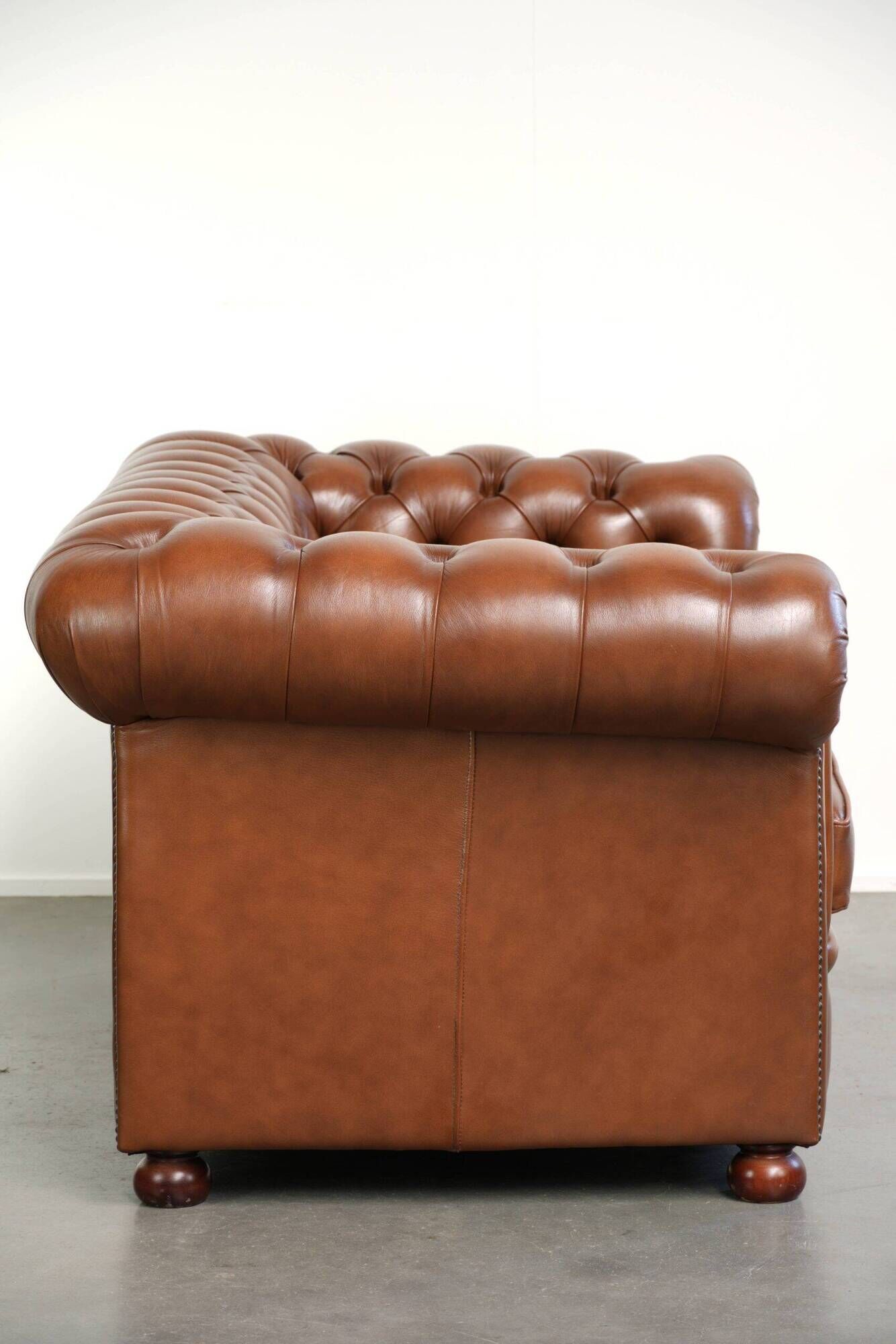 Very spacious 2-seater Chesterfield sofa in cow leather in a English look