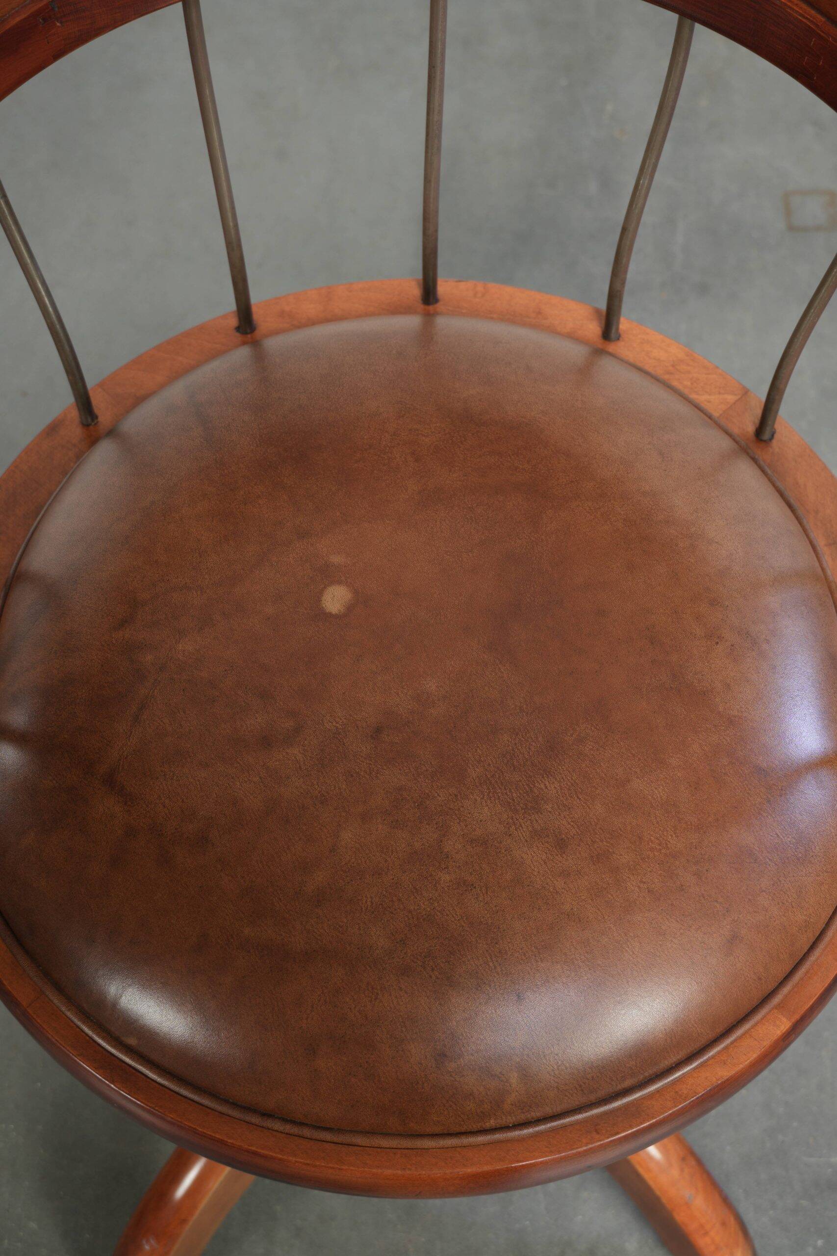 Set of 2 swivel/office chairs with a cognac-coloured cow leather seat