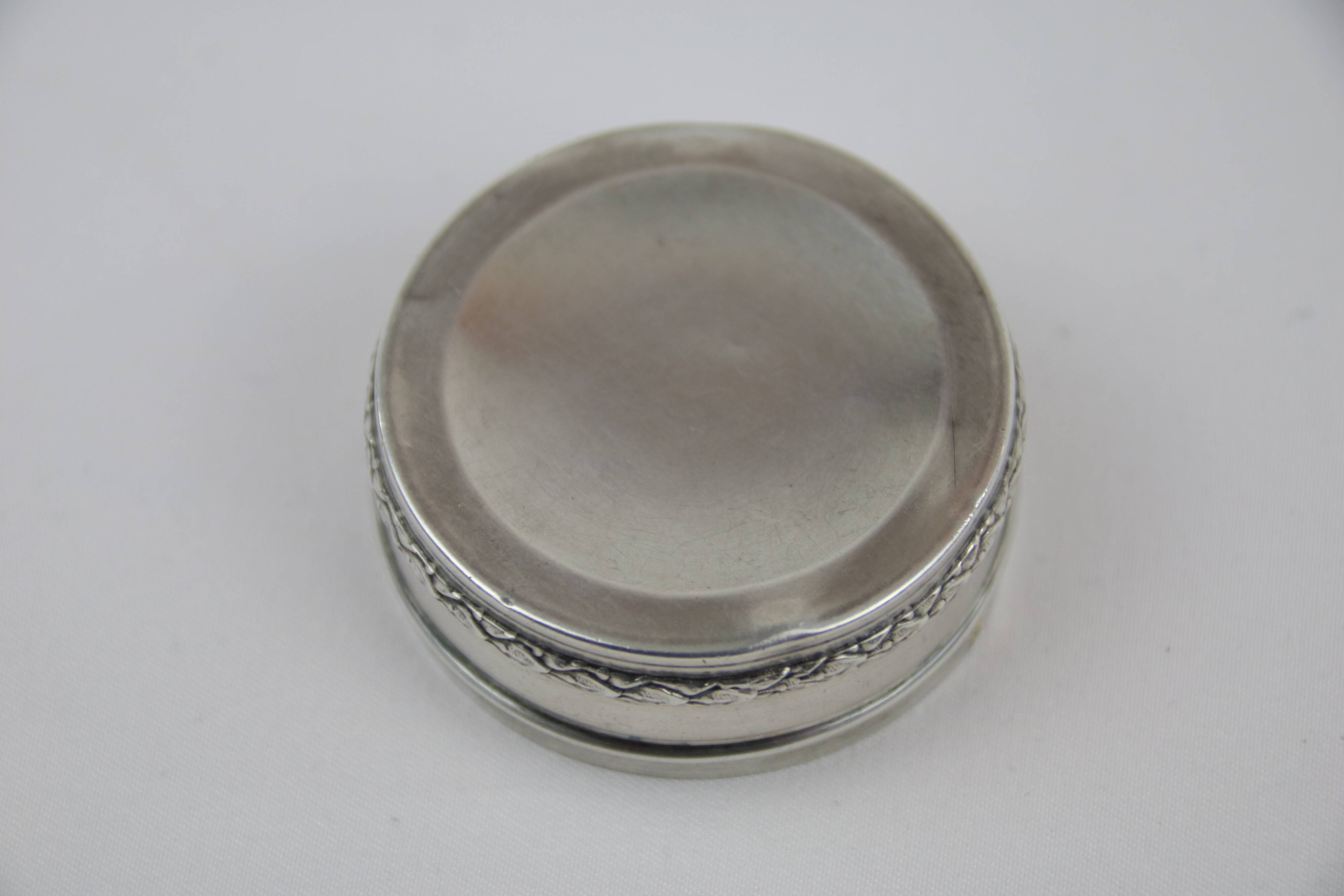Small round box with silver pills