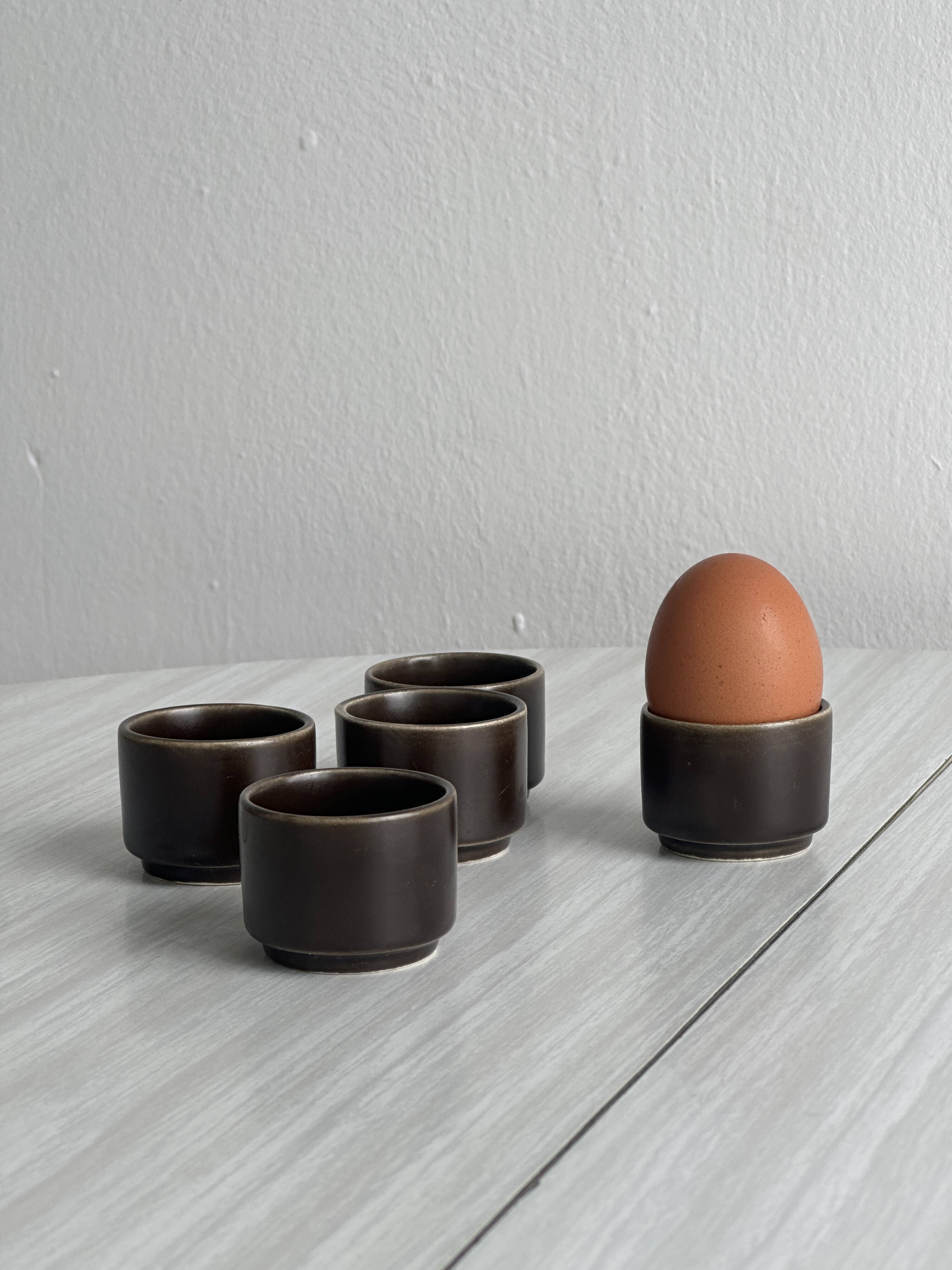 Set of 5 dark brown glazed ceramic egg cups.