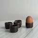 Set of 5 dark brown glazed ceramic egg cups.