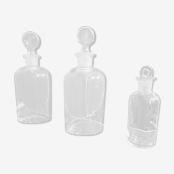 Trio of old apothecary bottles with their caps