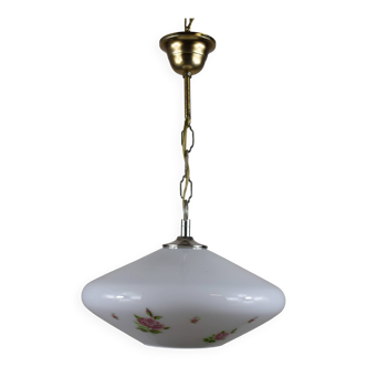 White glass pendant light with flower motif.