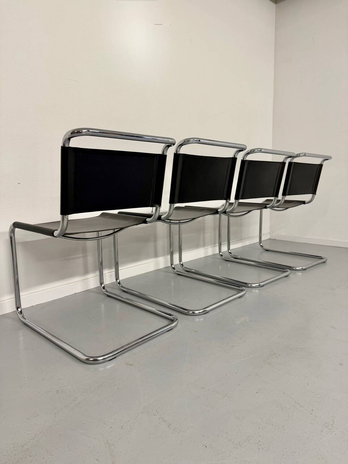 Lot of 4 tubular chairs designed by Mart Stam in vintage black leather from the 1980s.