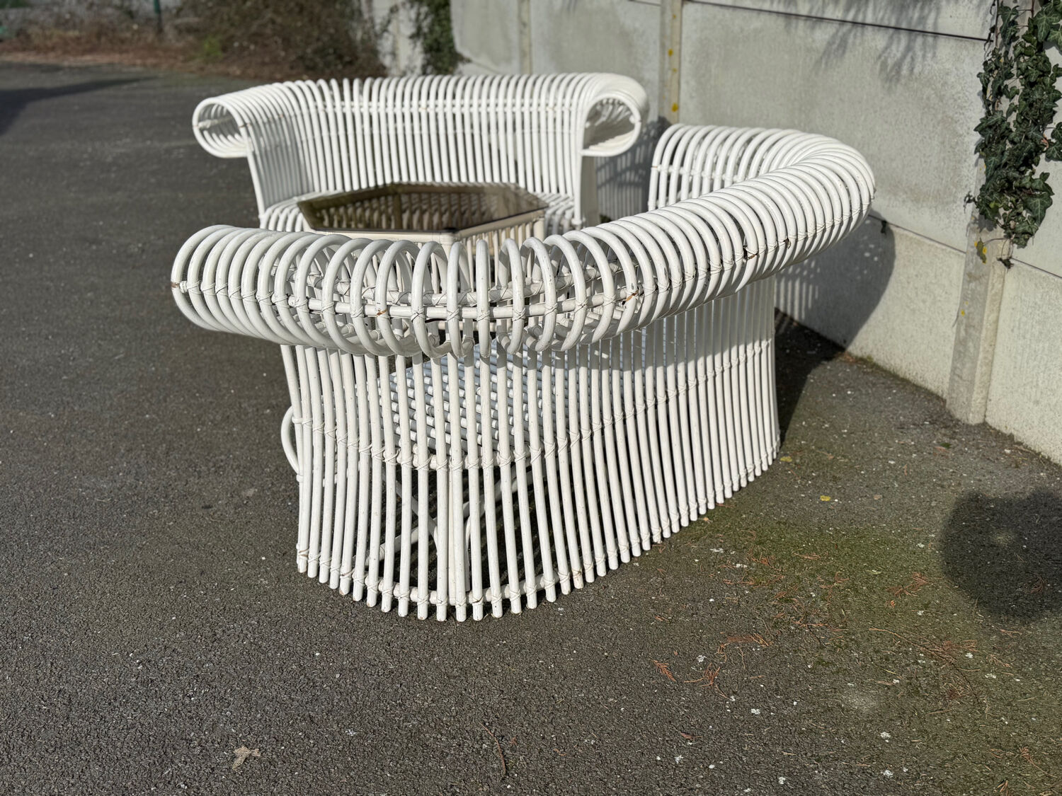 Rattan lounge with two two-seater sofas and a white coffee table.