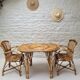 Vintage Audoux Minet bamboo, rattan, and smoked glass table duo.