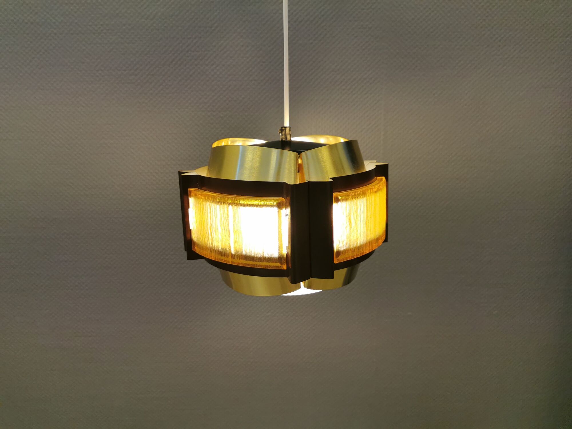 Danish hanging lamp, made in brass colored and brown metal, with yellowish hard pressed plastic deta