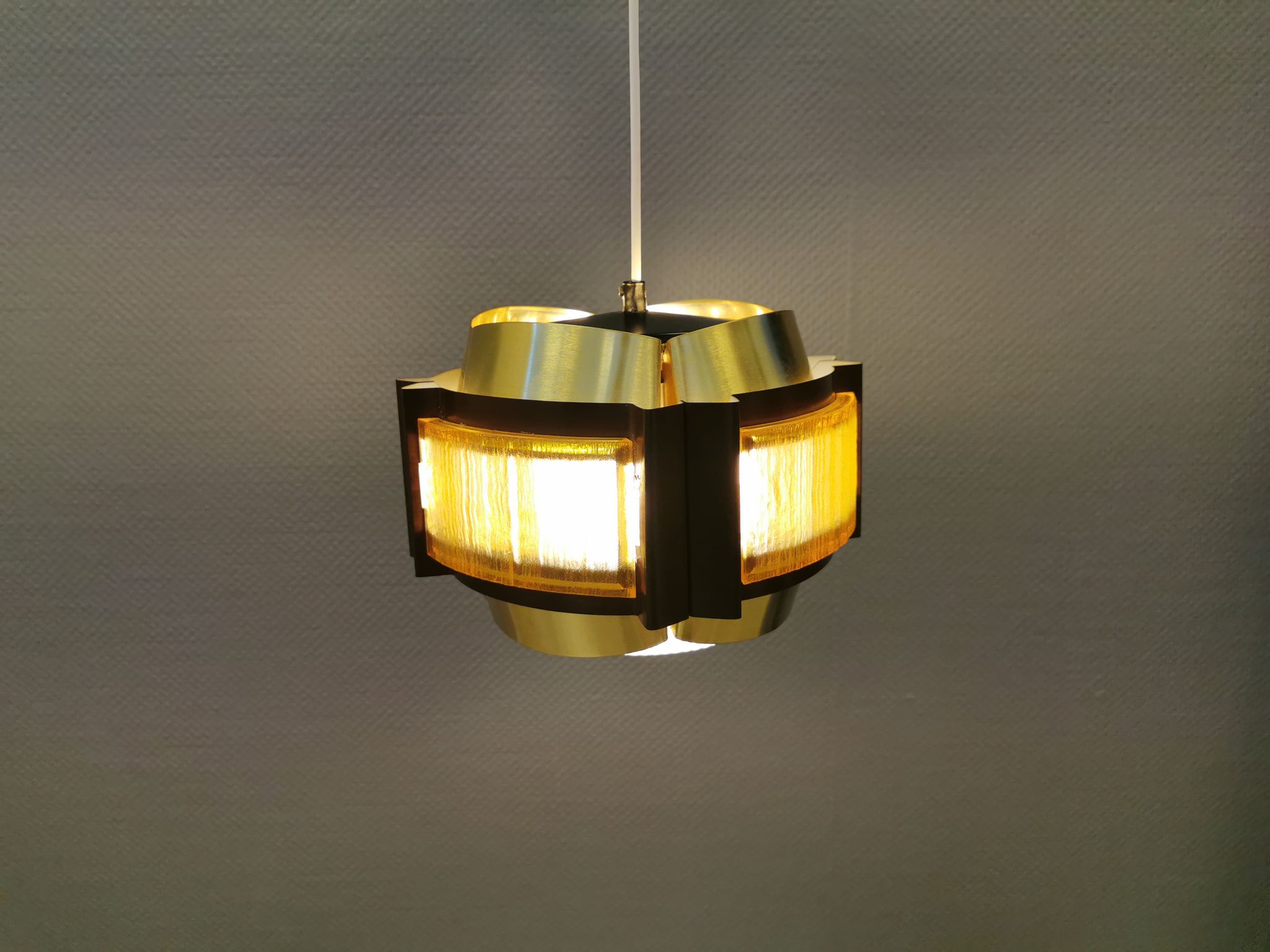 Danish hanging lamp, made in brass colored and brown metal, with yellowish hard pressed plastic deta