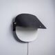 Matte black wall lamps with perforated shades and brass details