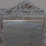Chic and stylish antique mirror with carved wooden frame in whitewashed