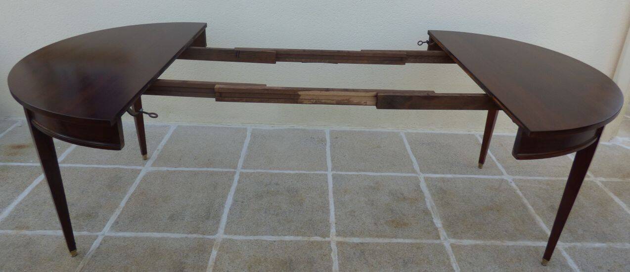 Round mahogany table with mahogany veneer and brass sabot foot.