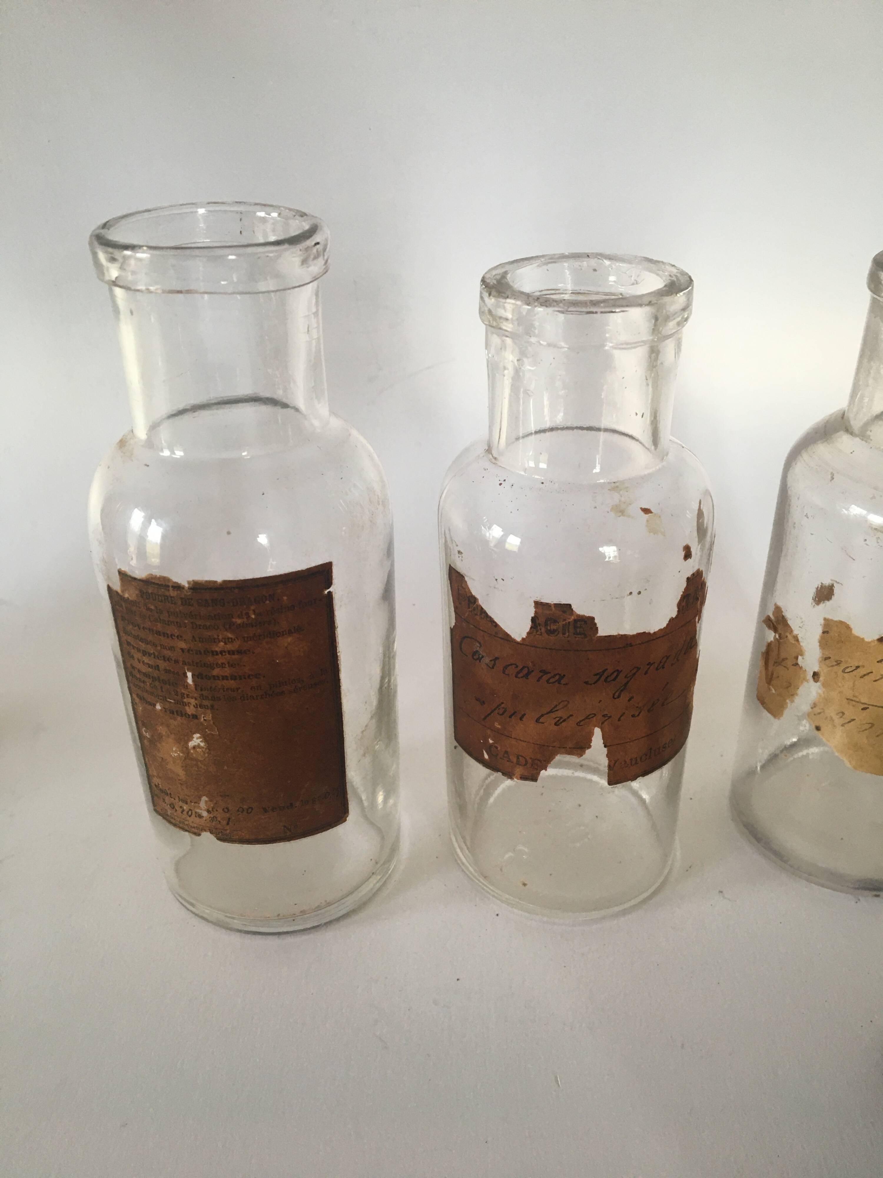 Trio apothecary bottles, painted metal caps