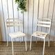 Pair of white metal bistro chairs
