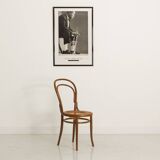 Bistro chair with curved wooden armrests and canning seat