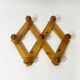 Accordion wall coat rack in solid pine