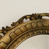 Old oval mirror in gilded resin