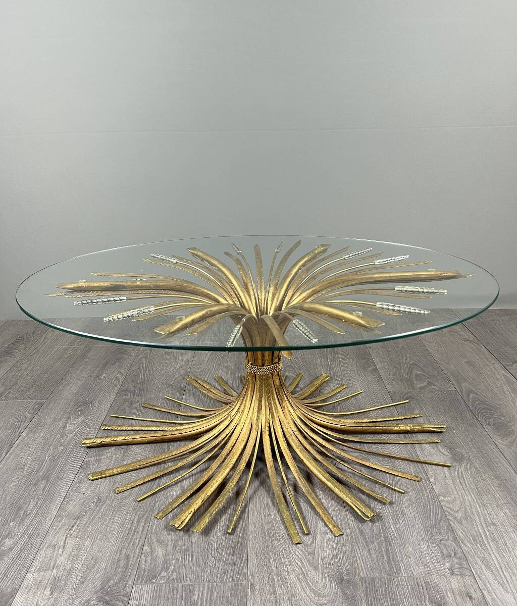 Gold metal and glass coffee table, 20th century, in the style of Robert Goos.