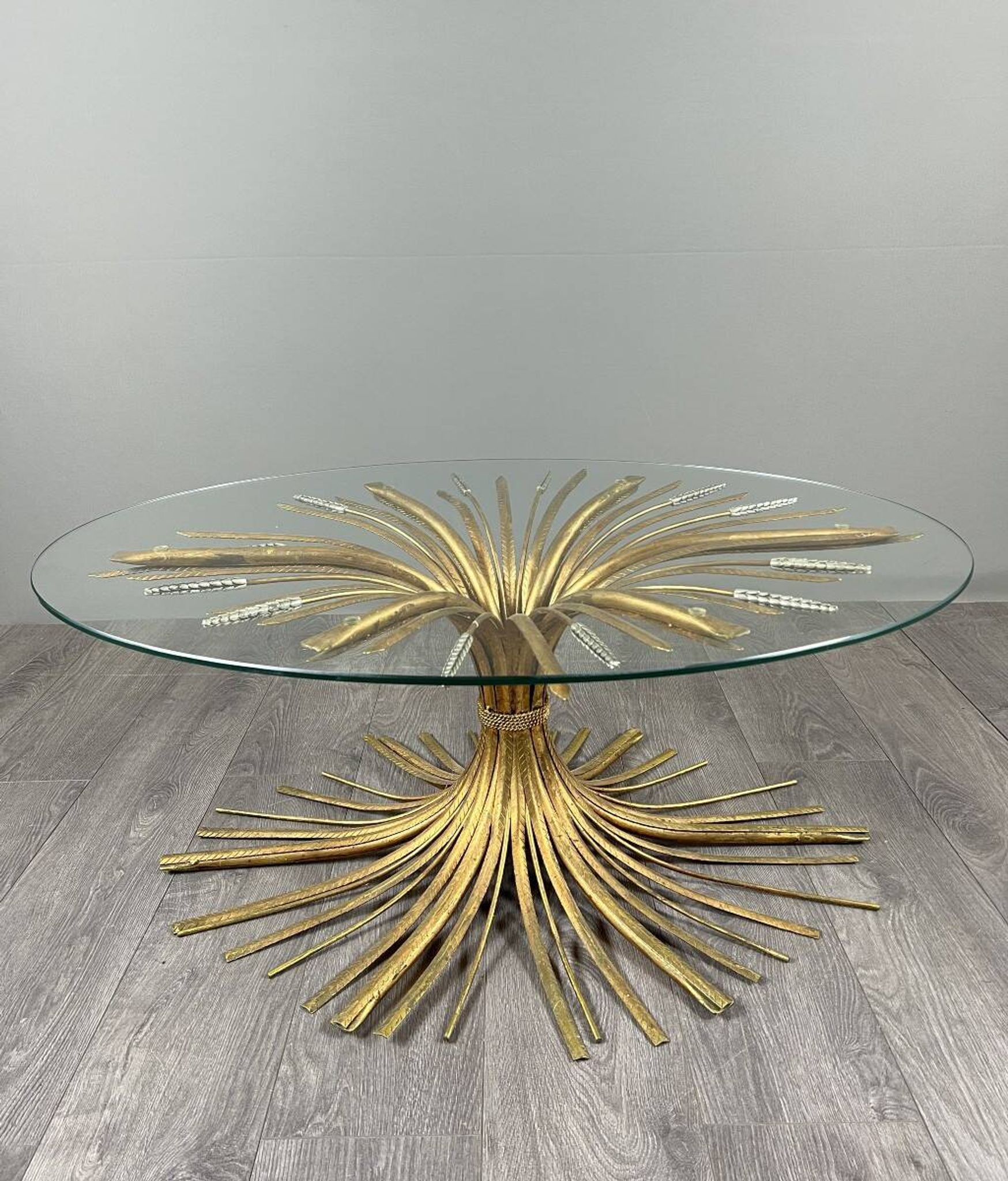 Gold metal and glass coffee table, 20th century, in the style of Robert Goos.