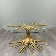 Gold metal and glass coffee table, 20th century, in the style of Robert Goos.