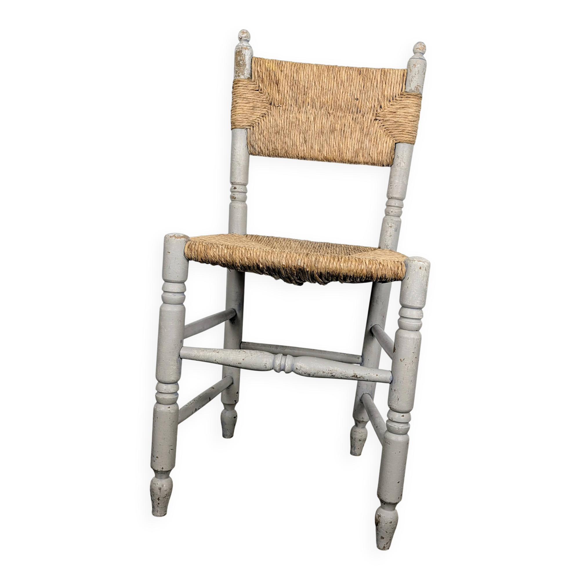 Rustic chair made of turned wood and straw.