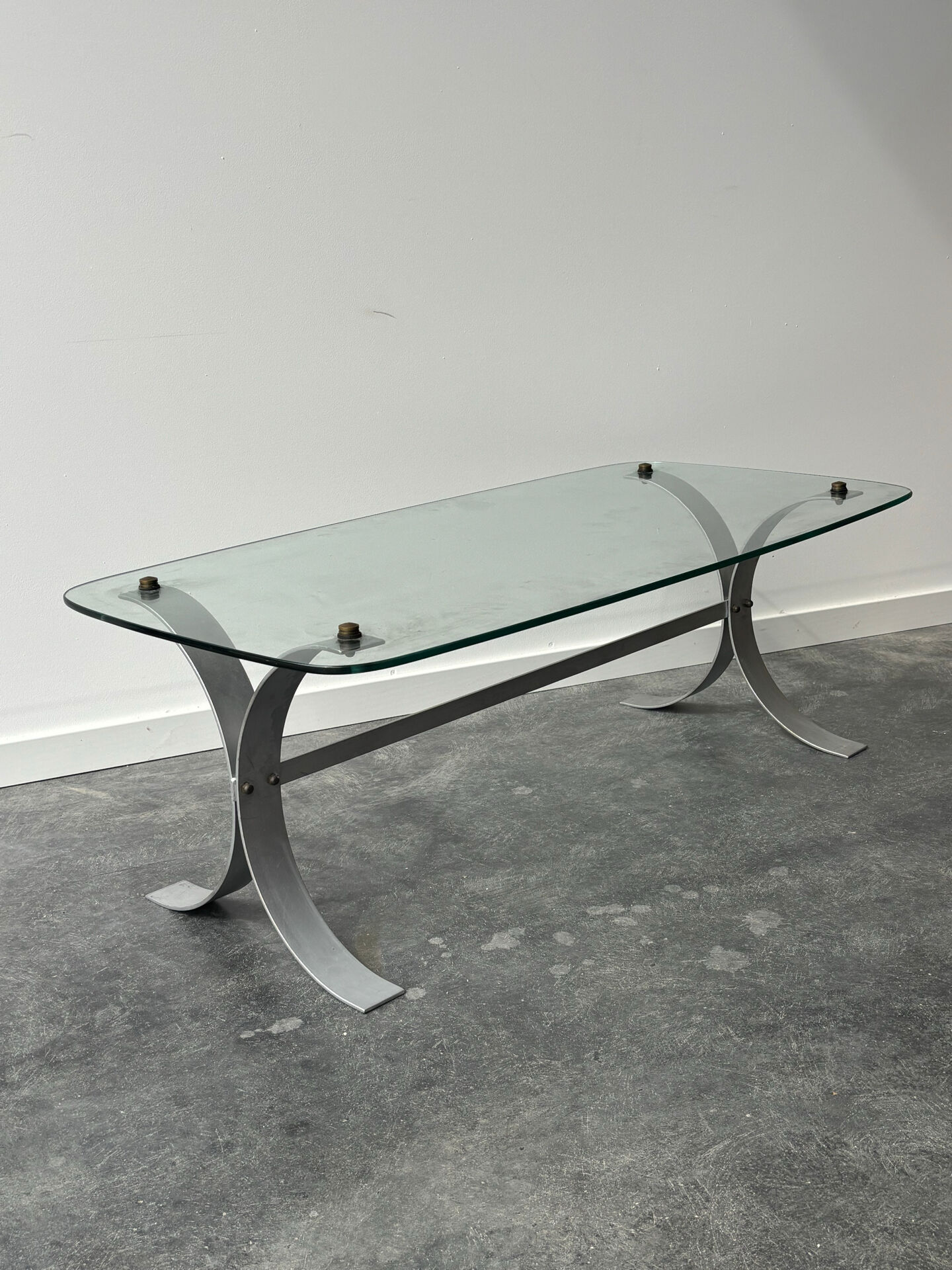 Design coffee table in brushed metal with a glass top, 1970s.