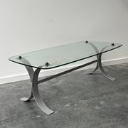 Design coffee table in brushed metal with a glass top, 1970s.