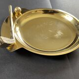 Round brass pocket tray with club and golf ball decoration.