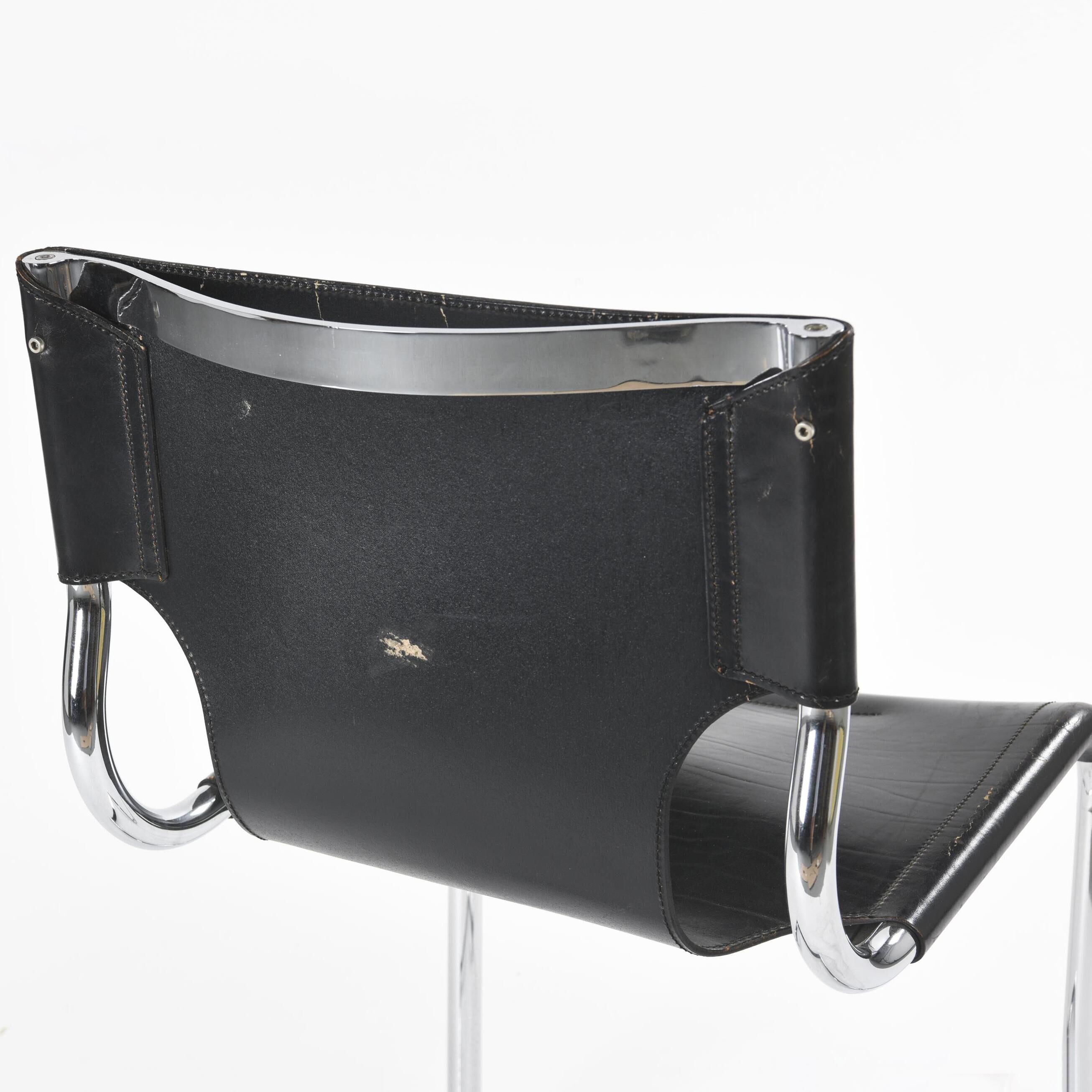 Black leather chairs by Carlo Bartoli