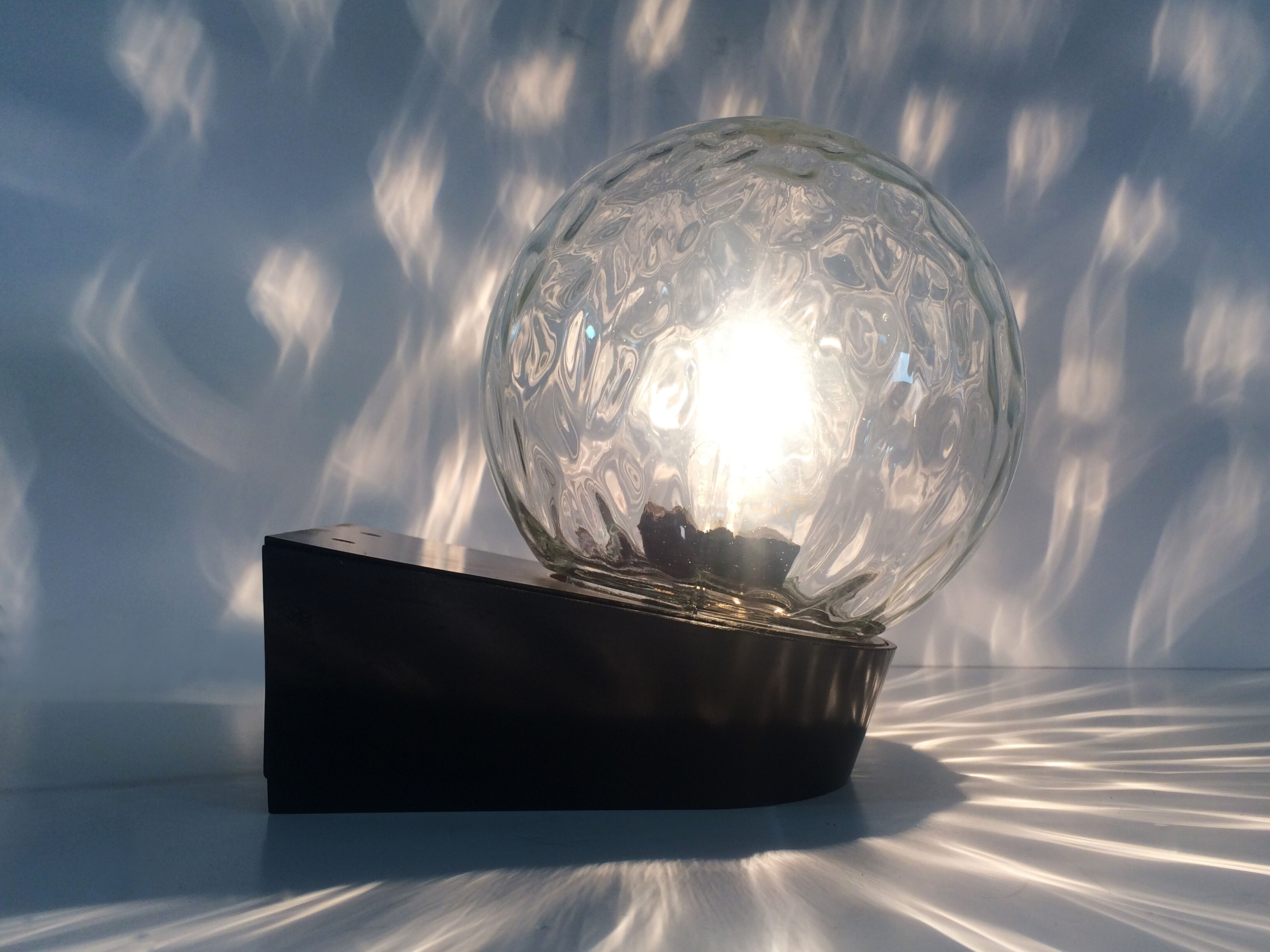 Vintage wall light plastic or bakelite structure, transparent glass globe. Year 70