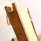 Vintage folding deckchair with yellow striped canvas