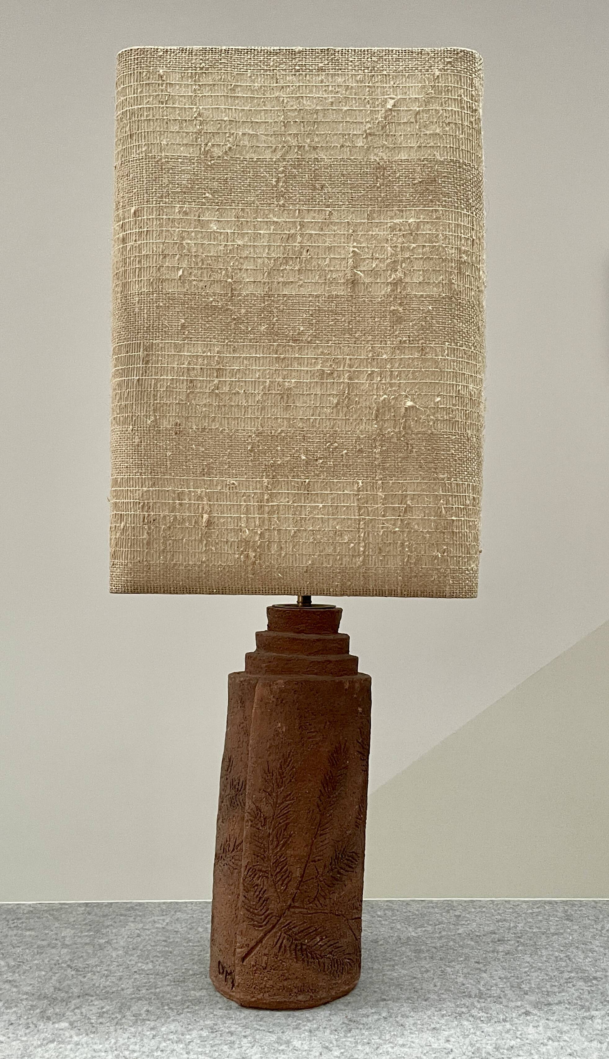 Large chamotte clay lamp in brutalist style, with a plant motif.