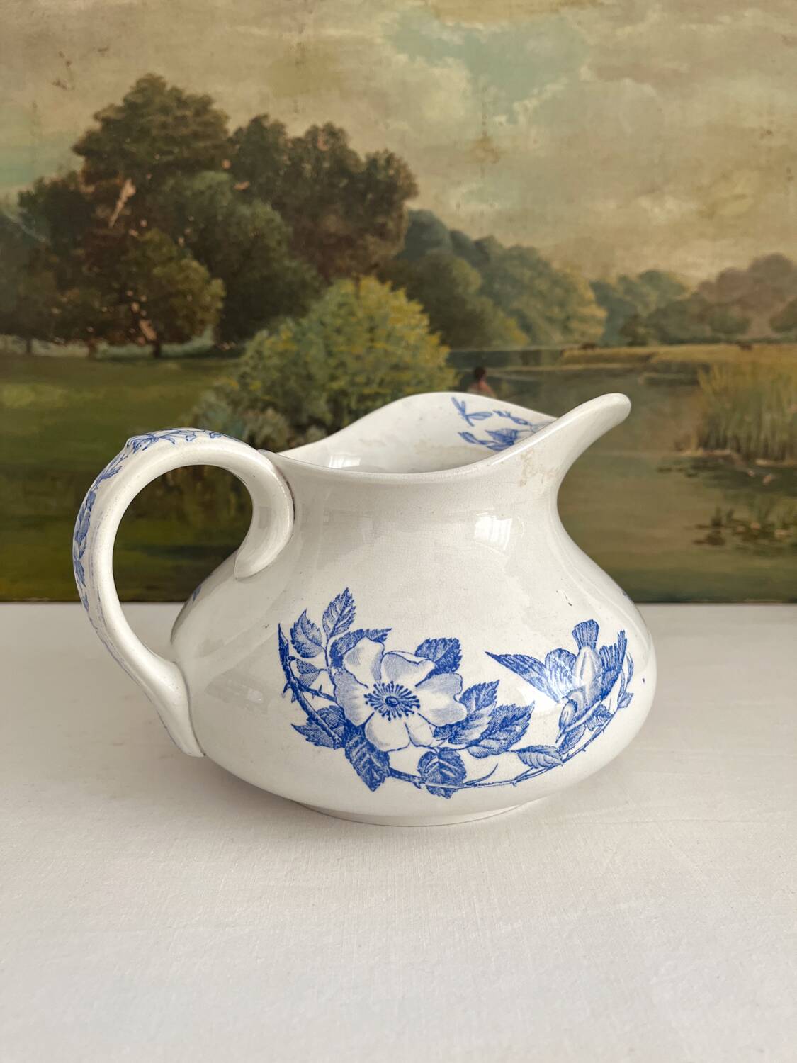 Antique chubby ironstone jug with floral and bird decoration