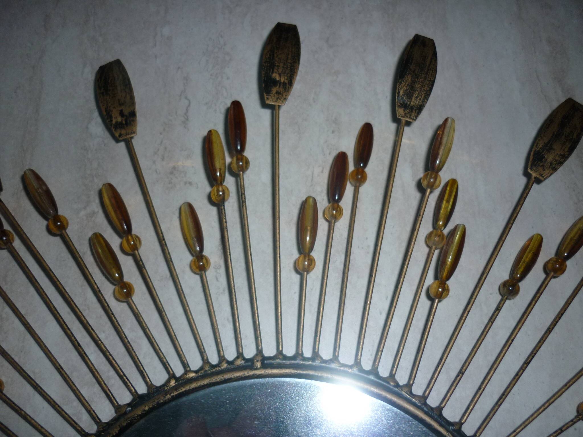 Round sun mirror with pearl rays and leaves