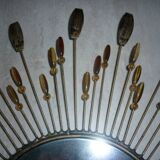 Round sun mirror with pearl rays and leaves