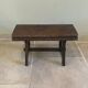 Small antique wooden bench with a folding backrest.