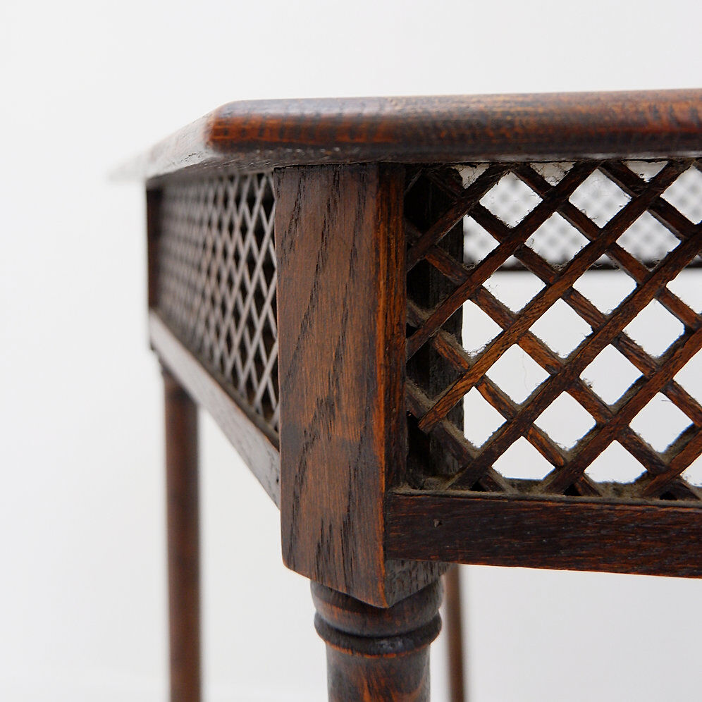 Hexagonal pedestal table or side table with a lattice structure and star pattern.