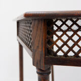 Hexagonal pedestal table or side table with a lattice structure and star pattern.