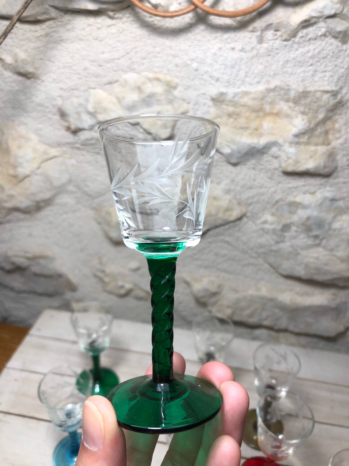 Antique and rare! Sold in a set of 12 colorful twisted stemmed glasses engraved with flowers and leaves