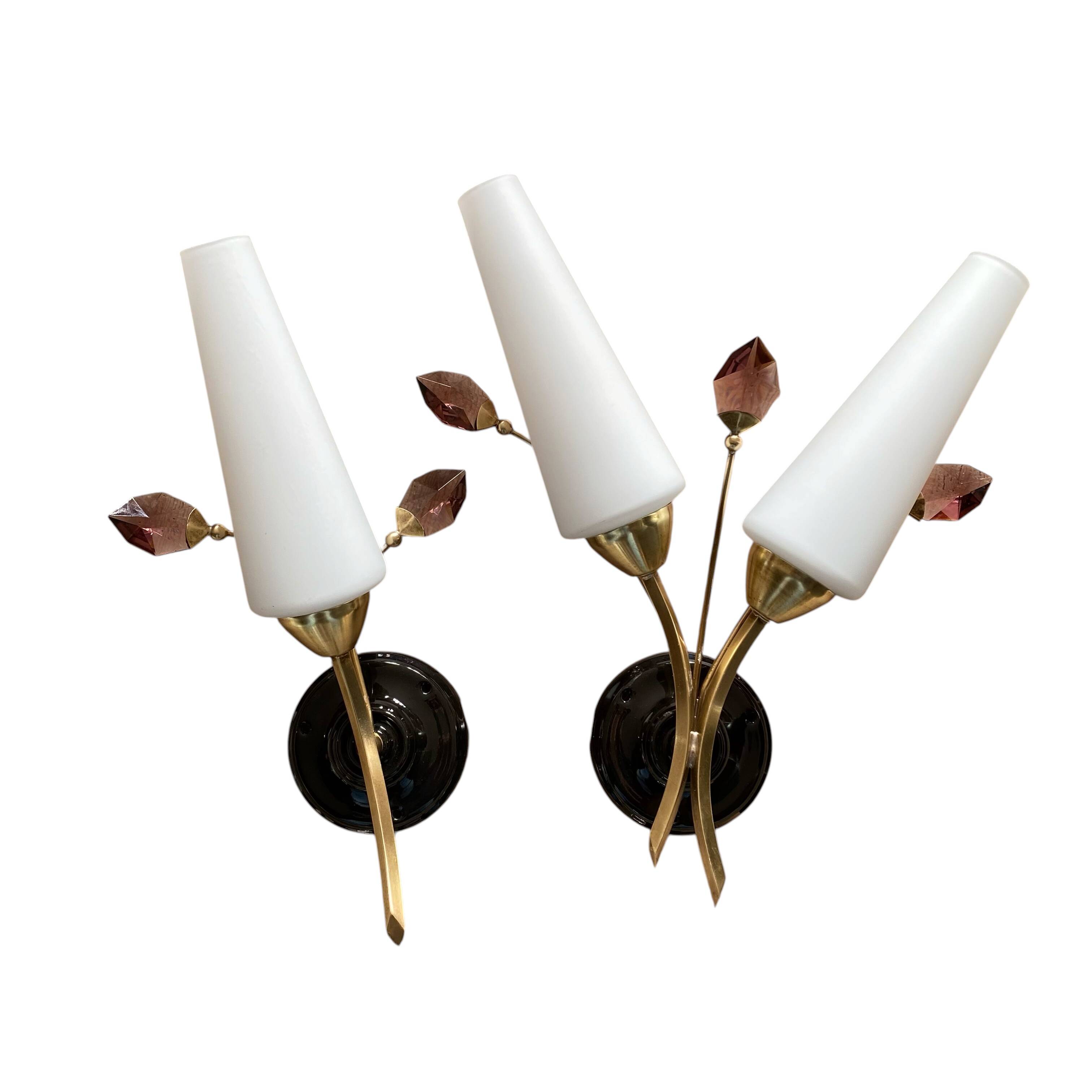 Pair of wall sconces in brass with white glass tulips.