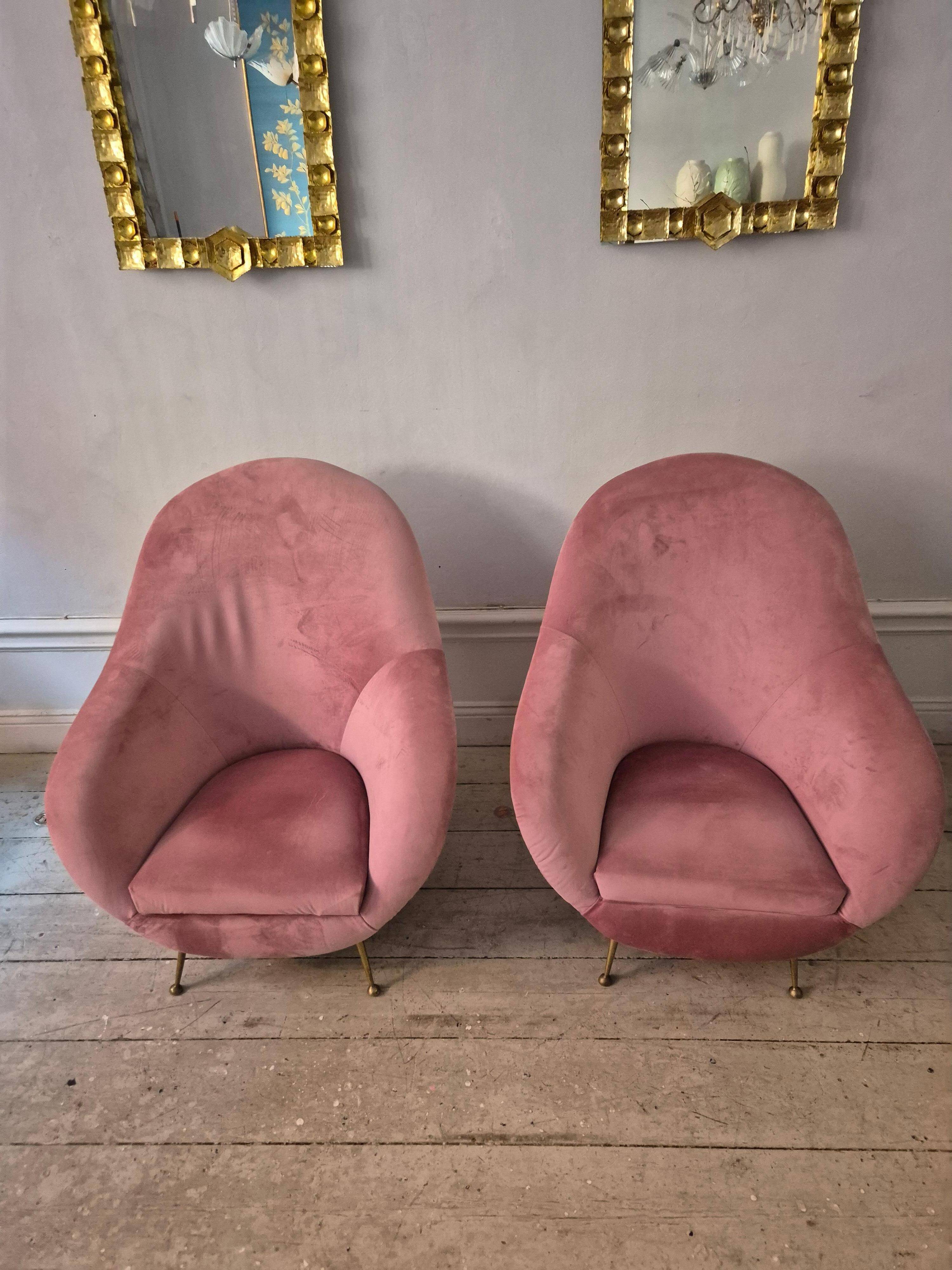 An elegant pair of armchairs with brass legs, Italy from the mid-20th century.