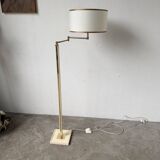 Floor lamp with articulated arm in brass-plated metal