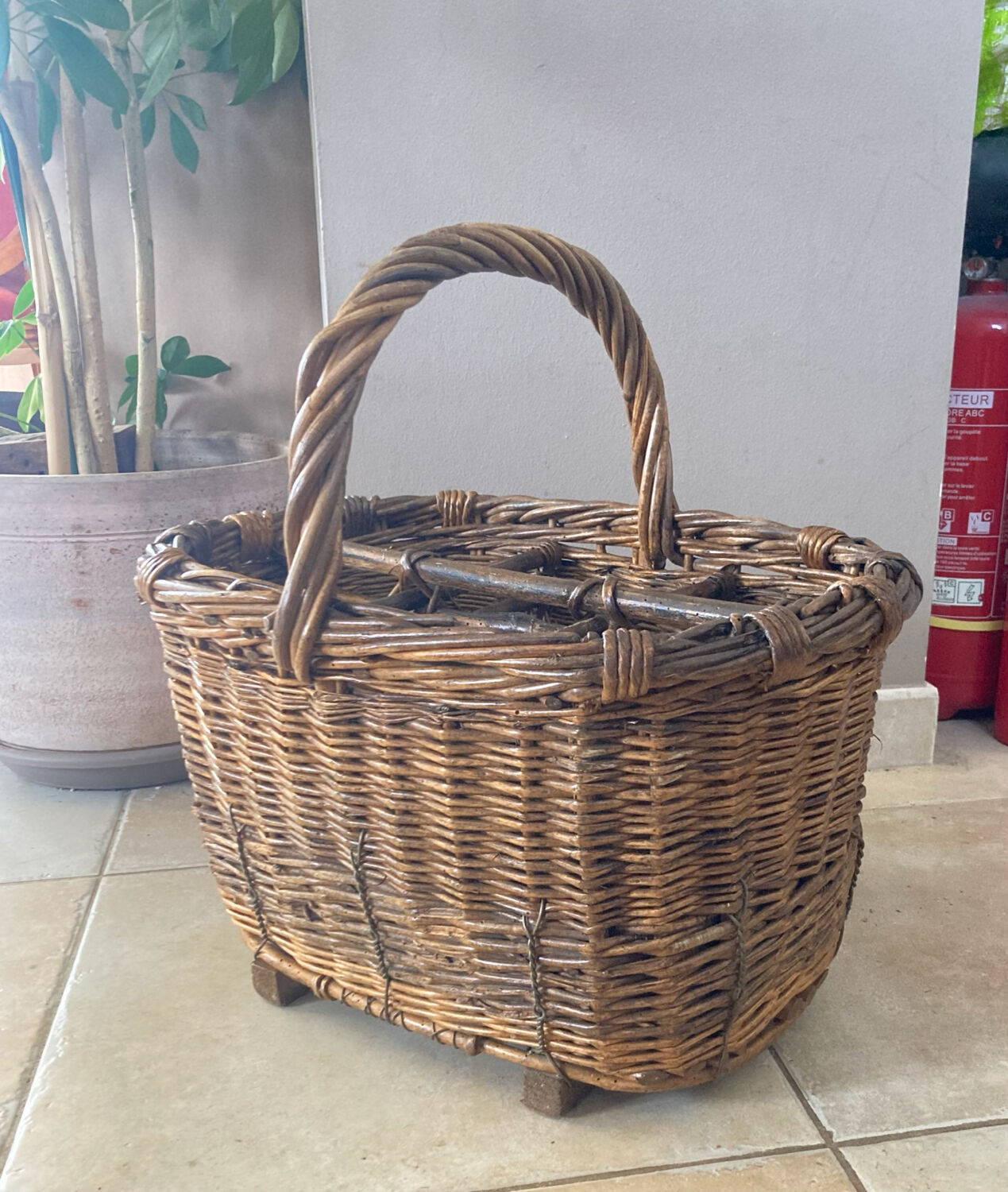 Wicker and hazel bottle basket from the early 20th century or possibly earlier.