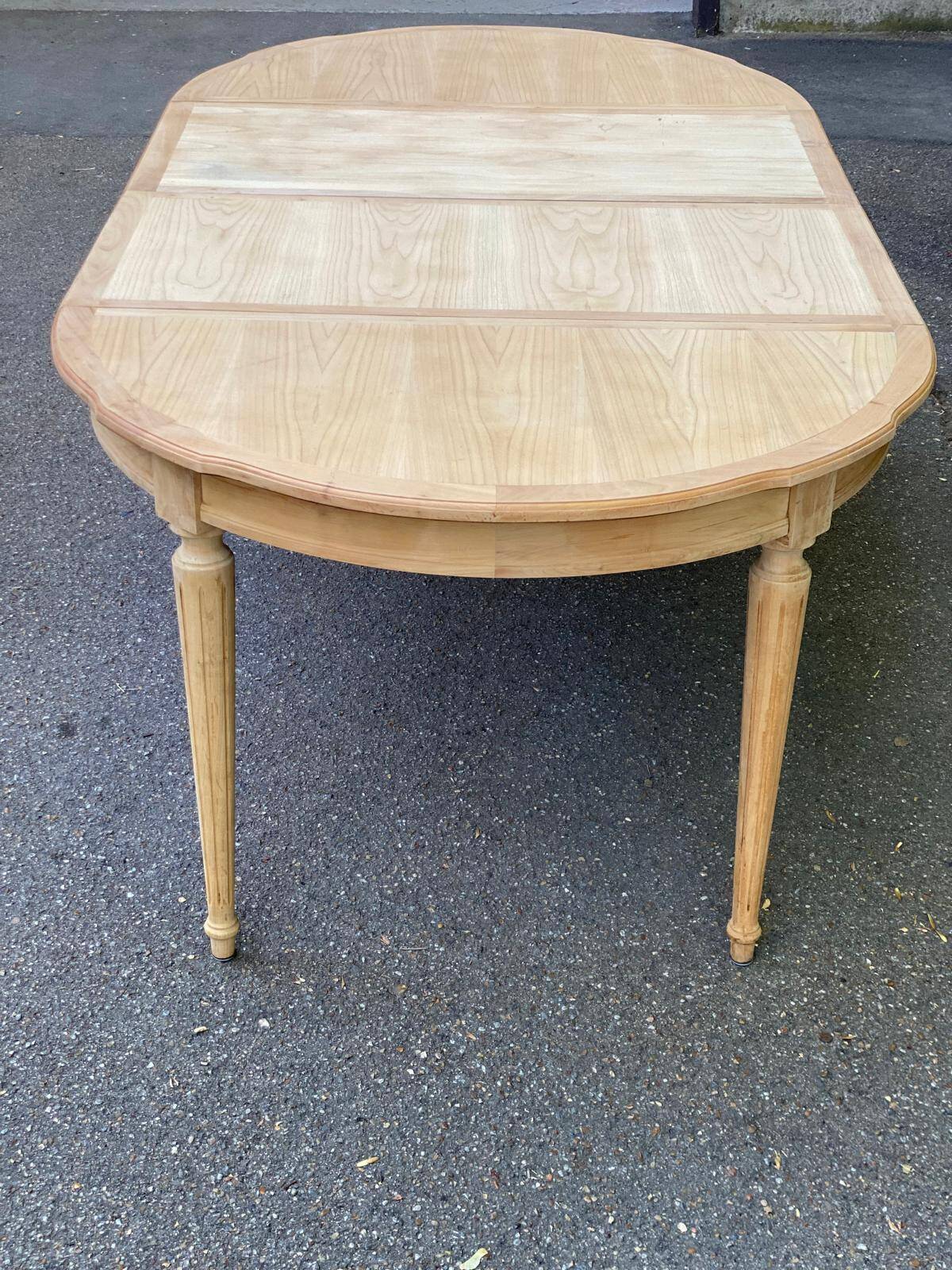 Extendable round table in renovated Louis XVI style, made of light wood, with 2 extensions.