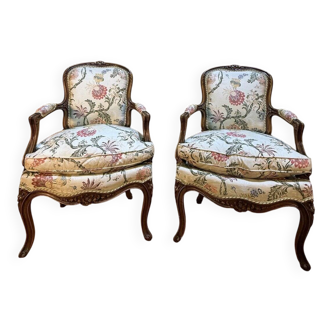 Pair of Louis XV style armchairs with floral fabric.