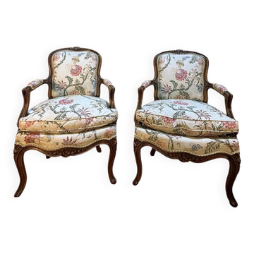 Pair of Louis XV style armchairs with floral fabric.