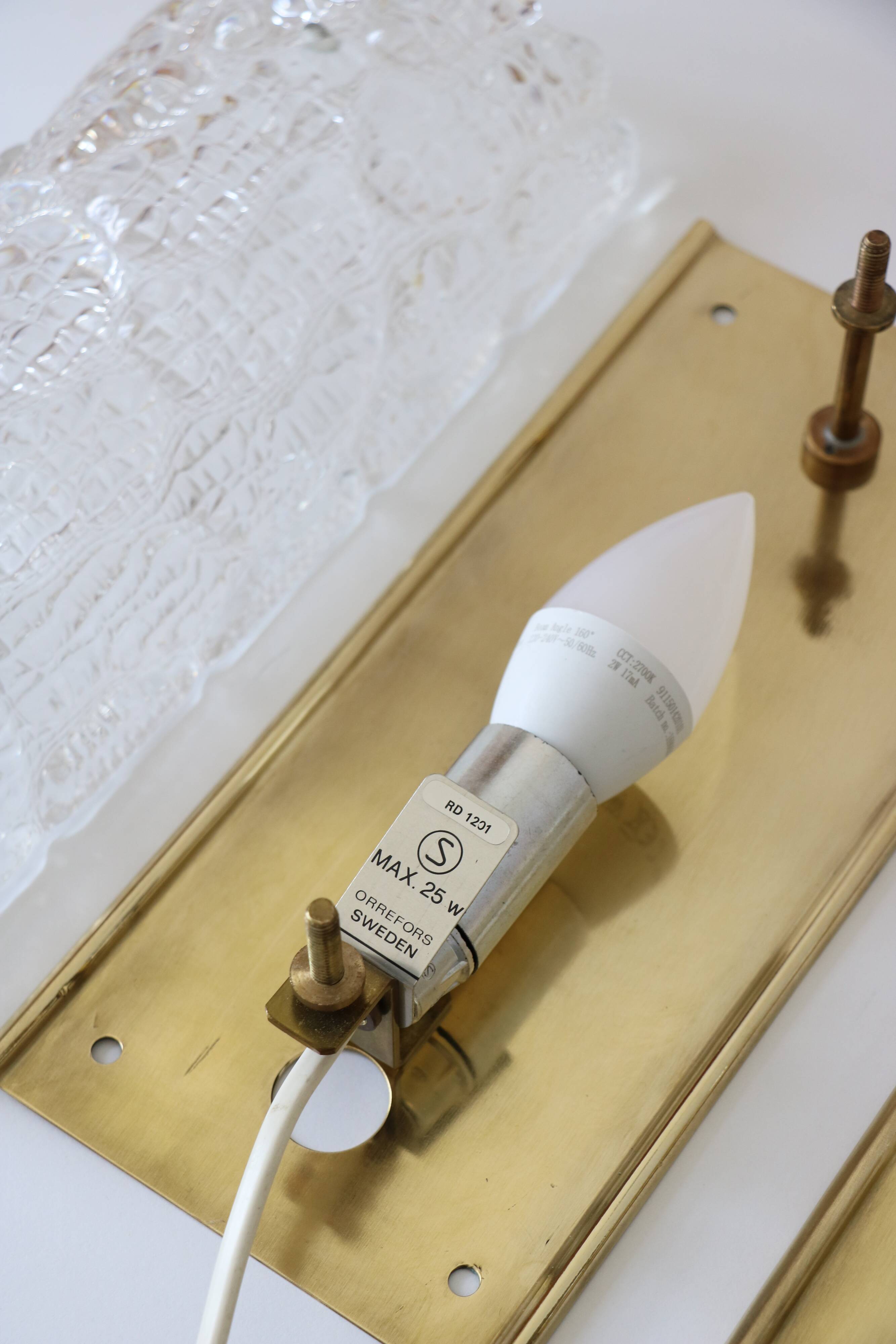 Pair of glass and brass wall lights by Carl Fagerlund for Orrefors.