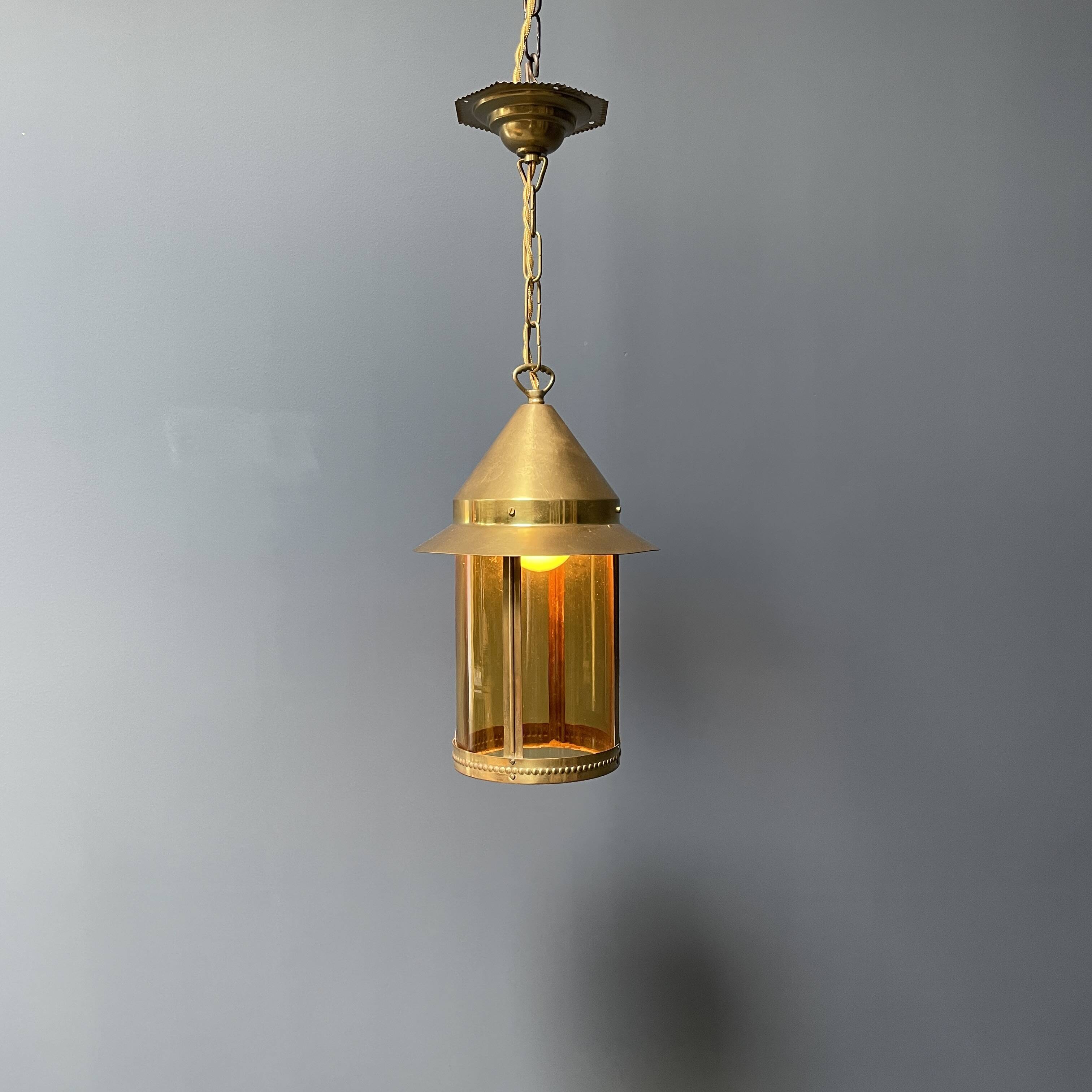 Brass lantern pendant lamp with yellow glass