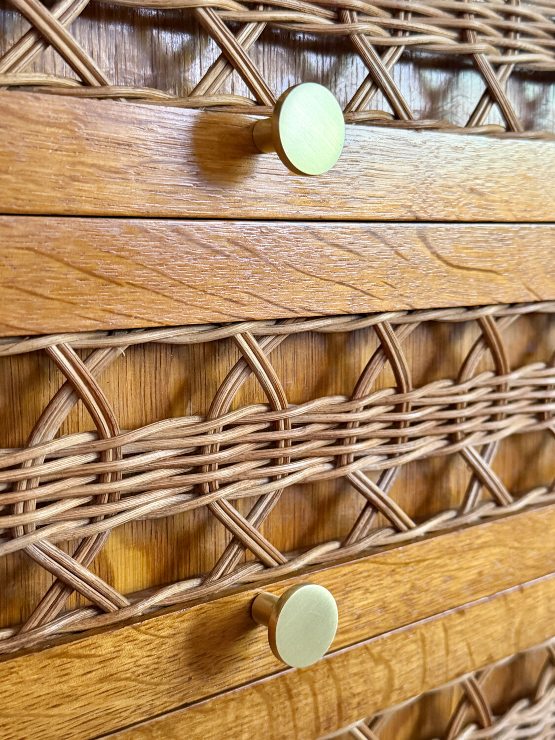 Vintage wooden and rattan chest of drawers with tapered legs.