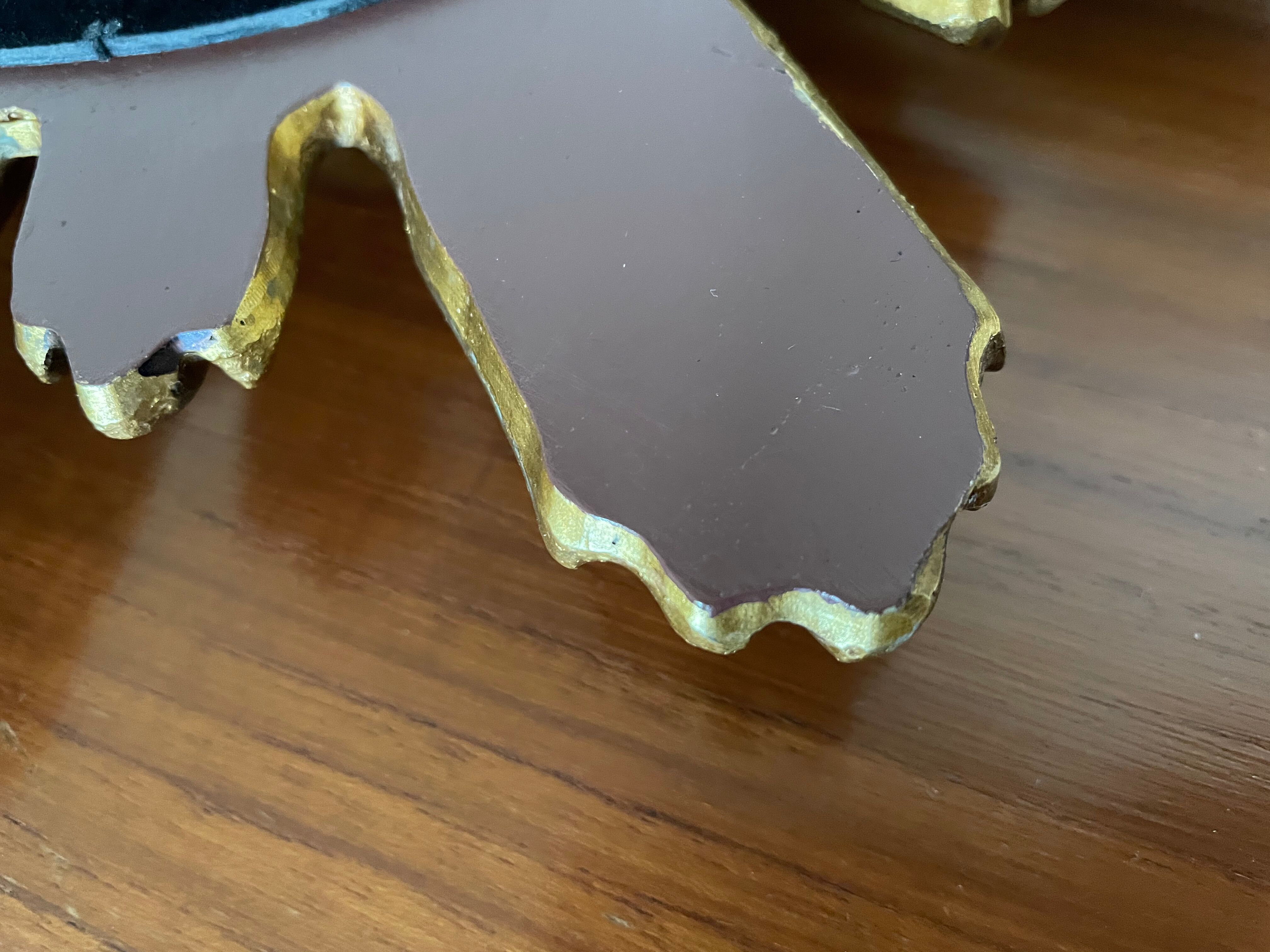 Vintage sun mirror in 60s/70s gold resin